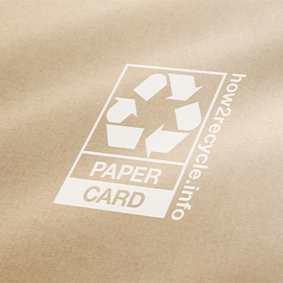 A close of up a simple recycling label on a craft paper color background.