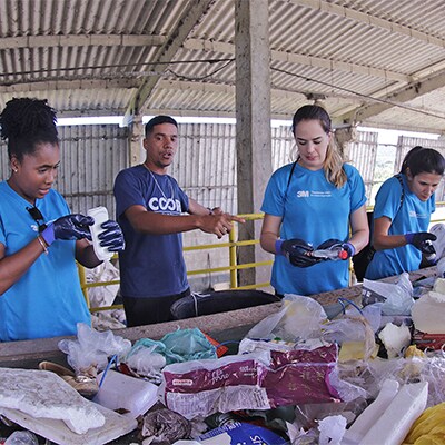 Community members sorting through garbage and recycling.