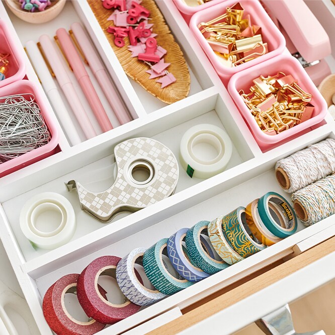 A colorful drawer of stationary supplies.
