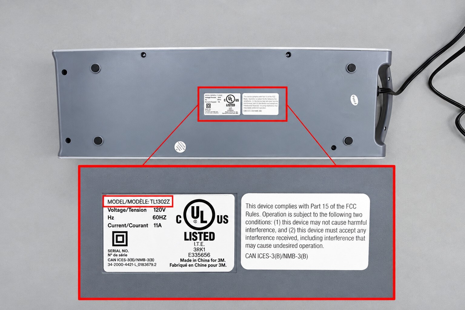 Close-up of a device's label showing model TL1302Z with UL certification and FCC compliance details.

