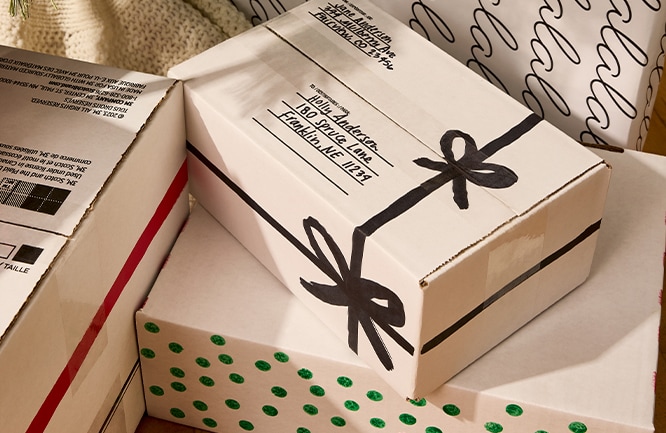 A pile of festive printed shipping boxes.