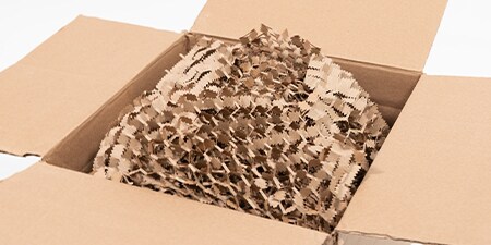 a cardboard box filled with Scotch™ Cushion Lock™ protective wrap
