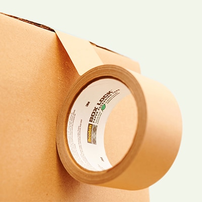 Scotch® Box Lock™ Paper Tape being wrapped across a cardboard box.