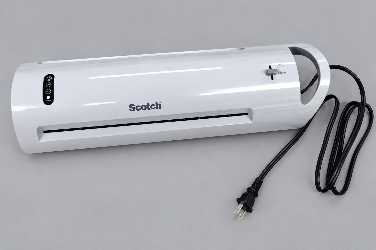 White Scotch laminator with controls and power cord on a gray surface.

