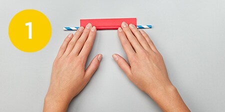 person cutting a rectangle out of a box
