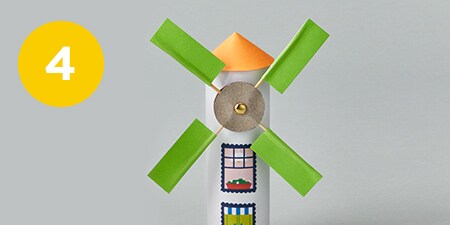 person making a small cone out of construction paper
