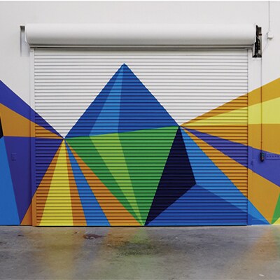A colorful geometric mural on a garage door.