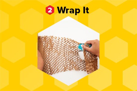 “Wrap it” hands wrapping a ceramic bowl in Scotch™ Cushion Lock™ Expanding Paper Wrap on a honeycomb patterned yellow background.
