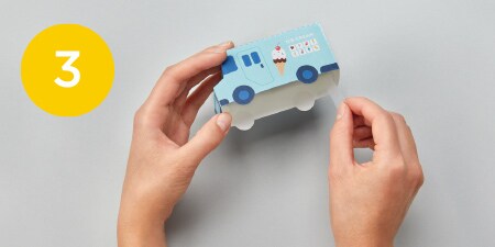 person taping automobile template
