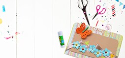 Scotch™ Brand Scissors and Glue, next to paper cutouts.