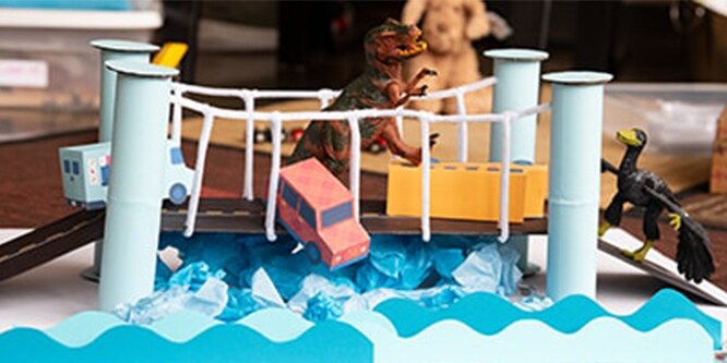 A DIY suspension bridge created with paper towel rolls and pipe cleaners.
