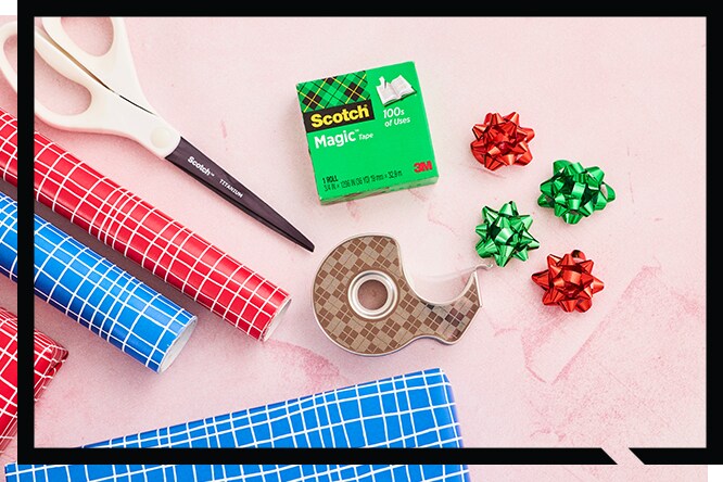 Gift decoration materials as paper, bows and scissors and tape dispenser.
