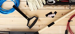 Gardening tools and Scotch™ Brand Fastening Products on a wooden surface.