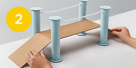 4 cardboard tubes and a flat piece of cardboard

