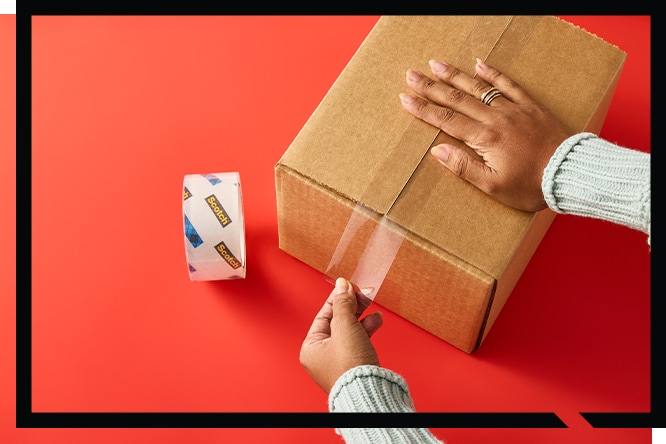 Hands sealing a cardboard box with clear tape on a red background, next to Scotch® Heavy Duty Shipping Tape .
