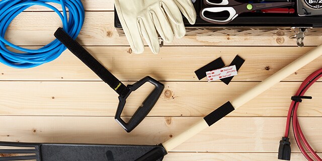 Gardening tools and Scotch™ Brand Fastening Products on a wooden surface.
