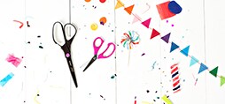 Scotch™ Brand Scissors surrounded by confetti and paper shapes.