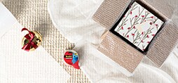 A gift, tulle, and Scotch® Brand Tape on a cloth surface.